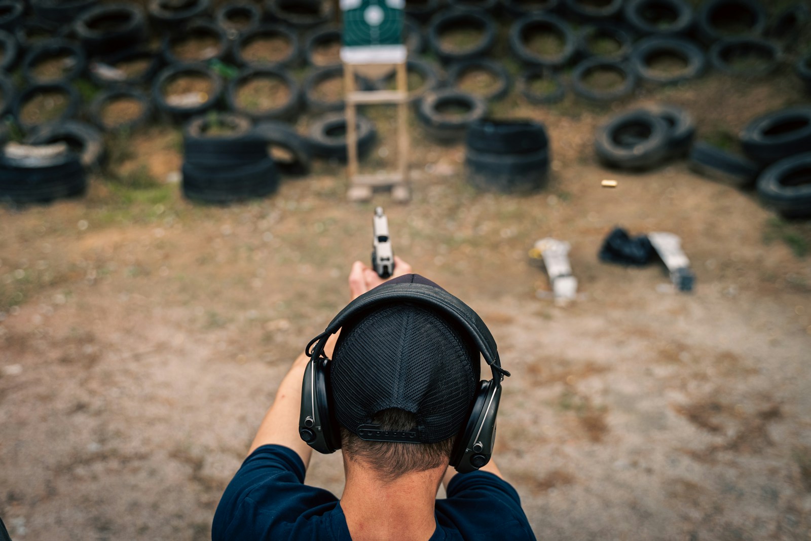 a man wearing headphones and holding a gun